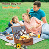 brown wicker picnic basket on blue blanket on the Grass