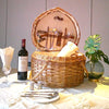 heart shaped natural wicker picknic basket open with wine and plates