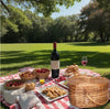 heart shaped natural wicker picnic basket on blanket with food