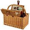 open wicker picnic basket with wine bottles