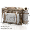 tan Wicker Picnic Basket closed with blanket strapped to it