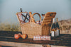tan wicker picnic basket open on table with wine