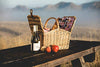 wicker picnic basket open with vaulted roof on table with wine