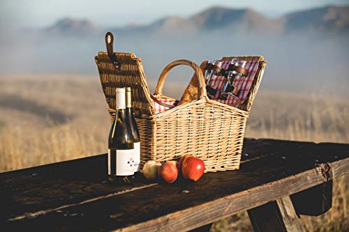wicker picnic basket open with vaulted roof on table with wine