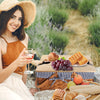 Pretty girl on blanket with wine and picnic basket