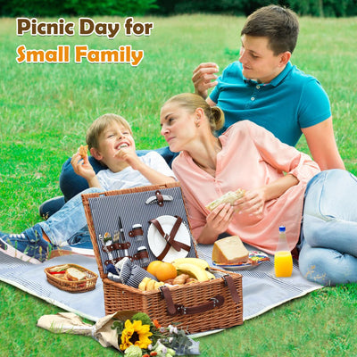 brown wicker picnic basket on blue blanket on the Grass