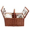 brown wicker picnic basket open white cloth and utensils 