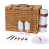 closed brown wicker picnic basket closed with plates, glasses, utensils
