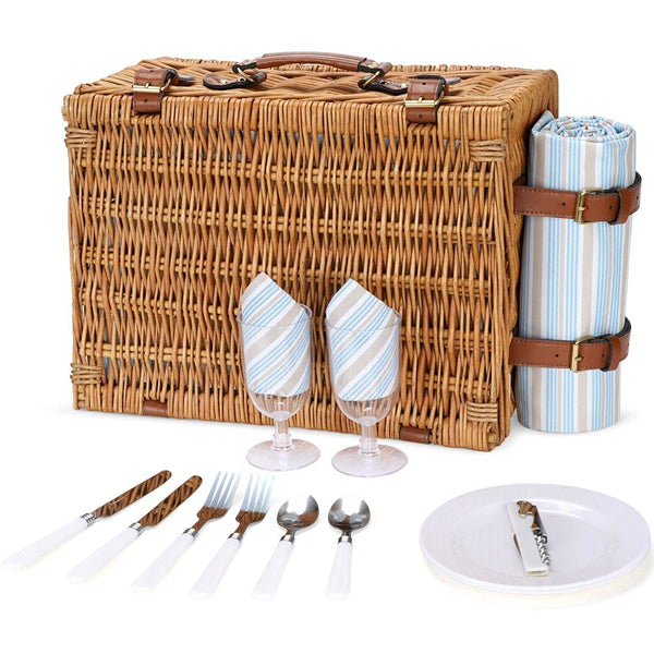 closed brown wicker picnic basket closed with plates, glasses, utensils