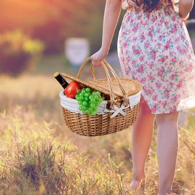 girl walking in grass with natural wicker picnic basket 