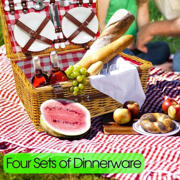 natural wicker picnic basket on red and white striped blanket with food