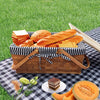 picnic basket on white and blue checkered blanket on grass