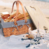 picnic basket on white blanket at beach