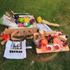 picnic basket wicker on grass full of food