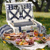 white wicker picnic basket open on grass