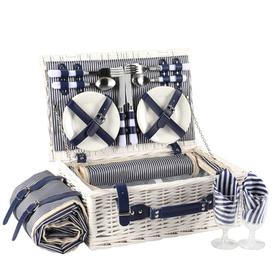 white wicker picnic basket open showing 4 person cups and plates