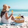 wicker picknic basket with white cloth insert on beach